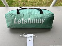 Green Letsfunny tent carry bag with black handles, closed.