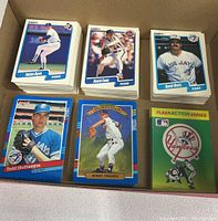 Top view showing stacks of 1990 and 1991 baseball cards by Fleer and Donruss, featuring players Nolan Ryan, David Cone, David Wells, Todd Stottlemyre, Bobby Thigpen, and a Fleer Action Series Yankees deck.