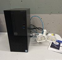 Dell PC and security light resting on table showing both items together