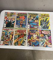 Eight Fantastic Four Marvel comic books laid flat, showing front covers in colorful vintage style art in plastic protective sleeves.