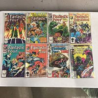Top view of 8 Marvel Fantastic Four comics laid out on a flat surface, showing front covers.