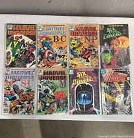 Front view of all 8 comic books arranged in two rows, showing titles and cover art.