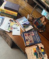Photo of collection on wooden table showing manuals, booklets, lamp and Heat Chips package on ceramic plate.