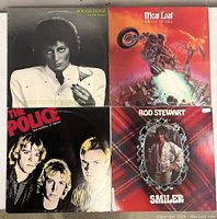 Top side of all four vinyl record covers showing front artwork for Rough Trade Avoid Fraud, Meat Loaf Bat Out of Hell, The Police Outlandos d'Amour, Rod Stewart Smiler.
