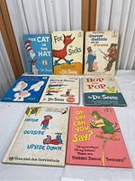 Front covers of 7 children's books including Dr. Seuss titles and others by associated authors, showing wear and damage.
