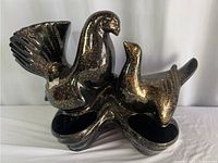 Front view of the black ceramic dual bird figurine with gold speckles, showcasing the overall design and condition.