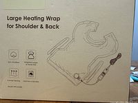 Box showing product line drawing and features: soft microfiber, weighted edges and hands free, 6 levels heating, machine washable, model HP16-018A.