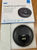 Box front showing product name and image of portable CD/MP3 player