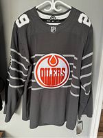 Full front view of dark grey Edmonton Oilers hockey jersey with number 29 and team logo.