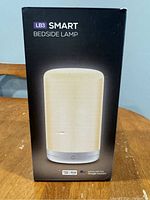 Front view of the LB3 Smart Bedside Lamp box showing lamp image and device compatibility.