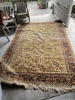 Full view of the wool area rug laid flat, showing detailed pattern and colors.