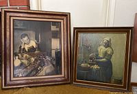 Photo showing two framed prints leaning against wall: A Woman Asleep on left, The Milkmaid on right.