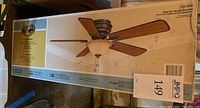 Original retail packaging for Hampton Bay Hawkins 44 inch ceiling fan showing full product image and fan blades configuration.