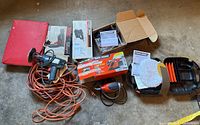 Overview of all power tools and accessories including cords, boxes, and padded dolly.