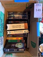 Box showing additional VHS tapes including The NeverEnding Story, Iron Will, Spy Kids, and The Iron Will