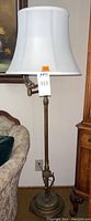 Full view of the vintage floor lamp with a white fabric lampshade.