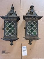 Pair of lanterns front view showing overall shape, roof detail, and glass inserts