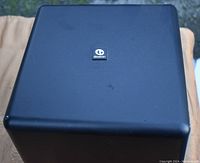 Top view of black Boston Acoustics subwoofer with logo on top surface, showing condition and finish.