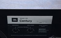 Front baffle close-up showing JBL Century Model L100 label with presence and brilliance controls