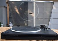 Front view of Kenwood KD-500 turntable showing platter, tonearm, and dust cover open.