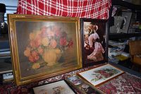 Photo of two framed art pieces: the floral painting on the left and the Victorian woman portrait on the right, showing size and frame details.