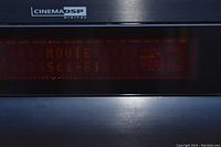 Close-up of receiver front panel display showing CinemaDSP digital readout 'MOVIE SOL-FI' and volume -05