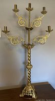 Full view of the French antique Victorian Gothic solid brass candelabra showing five arms and twisted central column.