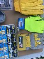 Photo showing three pairs of gloves and Philips light bulbs