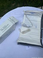 King size white electric heating pad with instructions and attached power cord laid out on table with open box.
