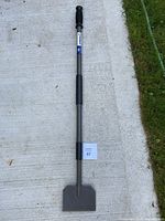 Full view of the Kobalt ice breaker tool showing the metal handle, rubber grip and flat steel blade.