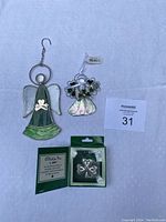 Three Irish-themed ornaments: two stained glass angels and one boxed metal angel