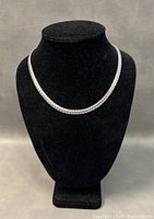 Full view of necklace on black display bust