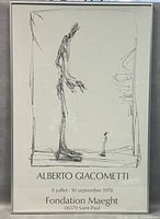 Full view of framed Alberto Giacometti black and white exhibition poster featuring a tall thin figure drawing.
