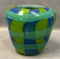 Front view showing rounded shape and checkered blue and green design.