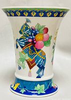 Front side view of porcelain vase showing decorated horse with fruit and leaves.