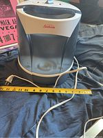 Side front view showing Sunbeam branding and rounded black and white body, measuring about 12 inches wide