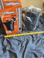 Photo of electric kettle next to its original box, showing size and design.
