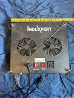 Top side of the grow light showing two cooling fans, power cord, universal power socket, and Bloom/Veg switches beneath a measuring tape for size reference.