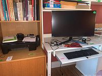 Wide view showing printer on shelf and desk with monitor, keyboard, some papers and accessories.
