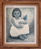 Frontal photo of the framed print showing the girl in white dress holding pineapple in grayscale.