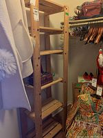 Front and side views of natural wood shelving unit with five shelves in a closet.