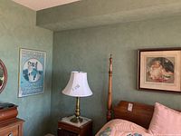 Framed cat poster print visible on another wall corner, showing partial text and image