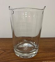 Front view of clear glass large ice bucket showing cylindrical shape, thick bottom and smooth surface.