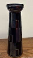 Front view of tall deep eggplant glass vase showing geometric pattern and flared rim