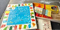 Board and game pieces of 1963 Mouse Trap game showing colorful board and components.