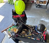 Top-down view of Craftsman toolbox with clear lid showing various tools and hard hats including mini screwdrivers, pliers, and tubing cutters