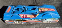 Blue plastic vintage Matchbox car carry case shaped like a race car with original numbered stickers on top showing '48 Car Carry Case'