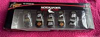 Front view of unopened package containing five 1/64 scale NASCAR cars from Winners Circle Hall of Fame series.