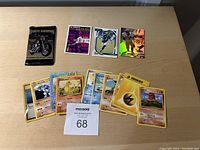 Assorted collectors cards laid out on surface, including Harley Davidson, Pokémon cards, and sports cards.
