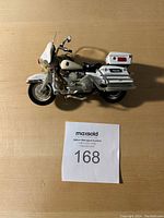 Top-down view of the white police toy motorcycle showing overall condition and details.